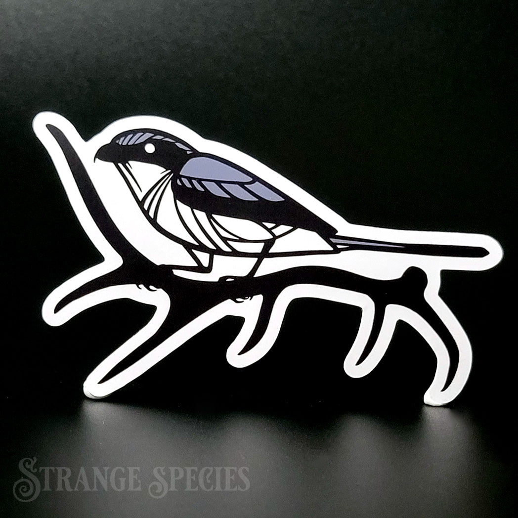 A sticker depicting a stylized drawing of a shrike bird, perched on an elk's antler.
